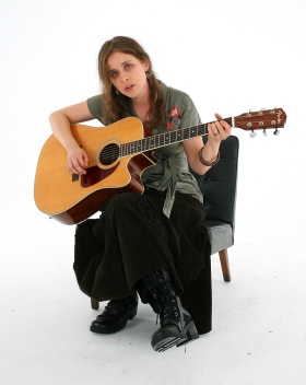 andreja seated with guitar